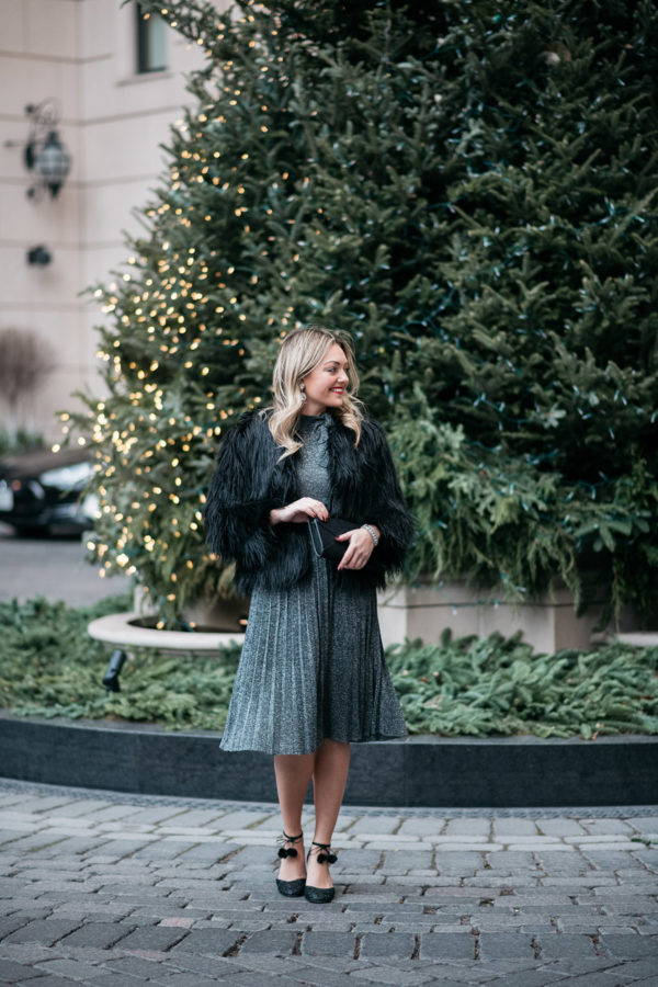 Jessica Sturdy wearing a silver Kate Spade pleated midi dress with a black fur coat.
