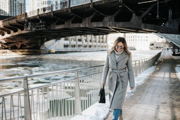Jessica Rose Sturdy wearing a Claudie Pierlot grey wrap wool coat and a grey turtleneck with mirrored sunglasses and a top-handle Polene bag in Chicago.
