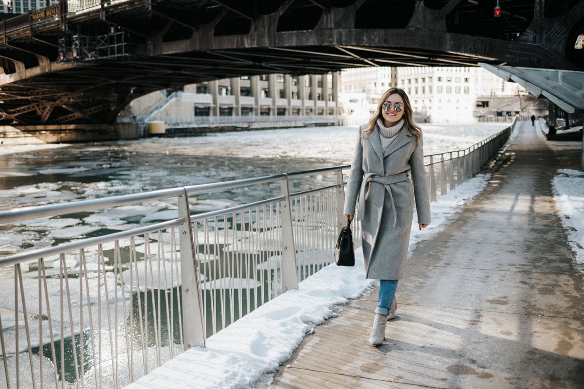 Chicago lifestyle blogger Jessica Rose Sturdy wearing a Claudie Pierlot grey wool coat, Vineyard Vines grey cashmere sweater, Rag & Bone boyfriend jeans, and Linea Paolo grey suede booties with mirrored sunglasses and a Polene Paris satchel.