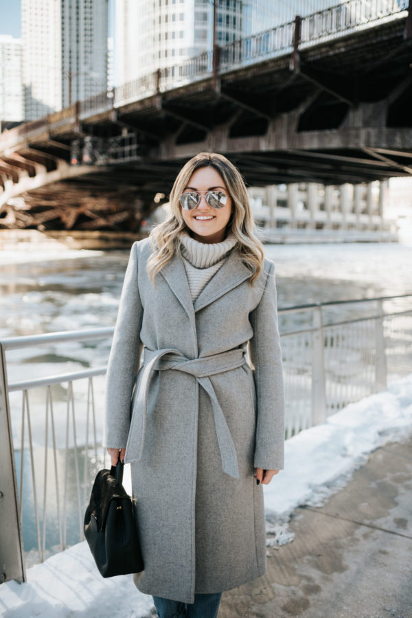Chicago blogger Jessica Rose Sturdy wearing a Claudie Pierlot grey wool coat, Vineyard Vines grey cashmere sweater, and Rag & Bone boyfriend jeans with mirrored sunglasses and a Polene Paris satchel.