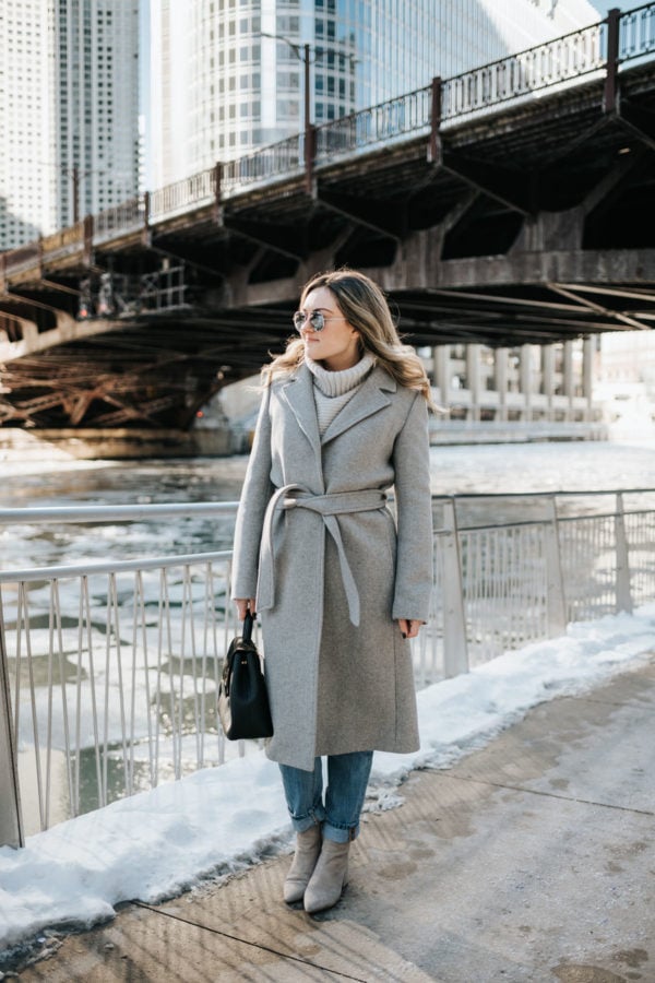 Chicago blogger Jessica Rose Sturdy wearing a Claudie Pierlot grey wool coat, Vineyard Vines grey cashmere sweater, Rag & Bone boyfriend jeans, and Linea Paolo grey suede booties with mirrored sunglasses and a Polene Paris satchel.