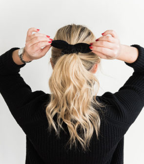 Jessica Sturdy wearing a black bow in her long blonde hair. She is sharing her tips, vitamins, and supplements to grow your hair longer and keep it healthy!