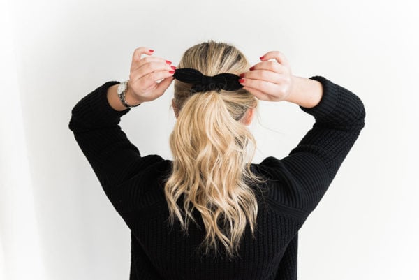 Jessica Sturdy wearing a black bow in her long blonde hair. She is sharing her tips, vitamins, and supplements to grow your hair longer and keep it healthy!