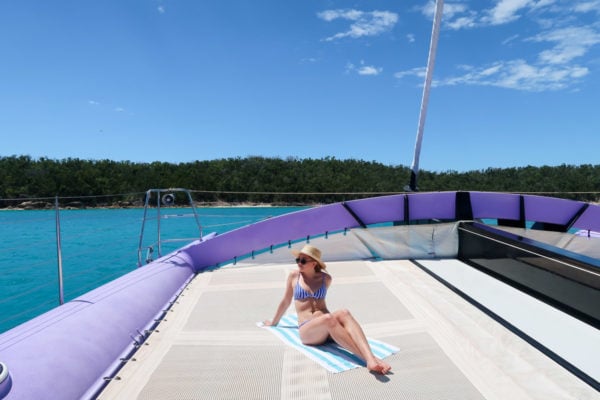 Jessica Sturdy wearing a striped swimsuit on a boat in the Whitsundays in Australia