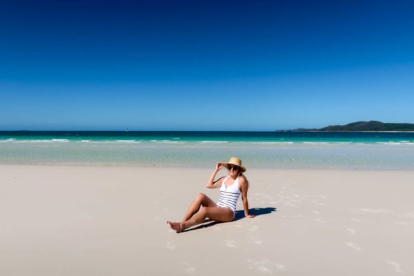 Jessica Sturdy wearing a striped one piece swimsuit on Whitehaven Beach in the Whitsundays in Australia