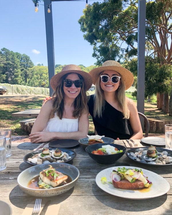 Hallie Wilson and Jessia Sturdy wearing black and white at a vineyard on the Mornington Peninsula in Australia
