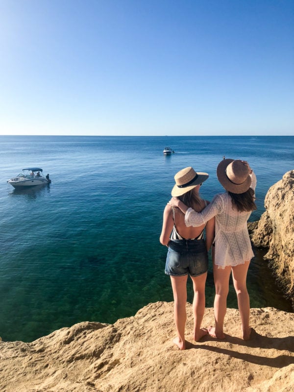 Jessica Sturdy and Hallie Wilson on a rock cliff on the Mornington Peninsula in Australia