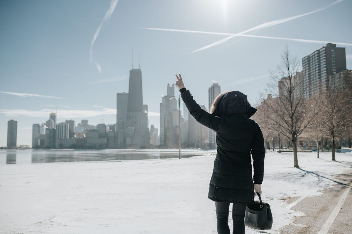 Chicago lifestyle blogger Jessica Sturdy wearing a Canada Goose jacket with a Polene top handle bag.