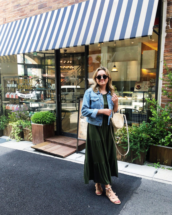 Jessica Sturdy in Kobe, Japan wearing an Old Navy maxi dress, denim jacket, Loeffler Randall pom pom sandals, Illesteva sunglasses, and a Clare V Straw tote