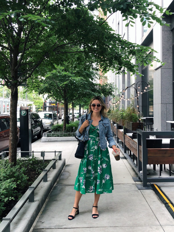 Bows & Sequins wearing a green floral dress with a denim jacket.