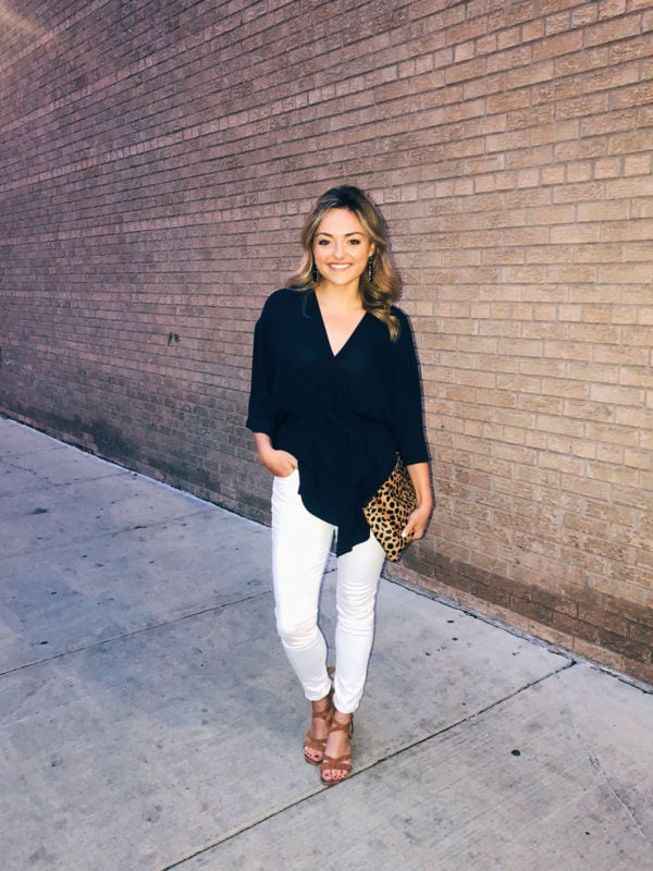 Chicago blogger Jessica Sturdy styling a navy blouse, white jeans, tan lace-up sandals, and a Clare V leopard clutch for a night out in the West Loop.