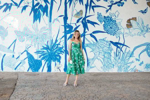 Popular Chicago blogger Jessica Sturdy taking photos in front of a blue and white mural in Chinatown.