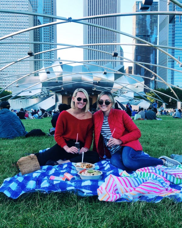 Chicago lifestyle blogger Jessica Sturdy wearing a red Barbour jacket at Millennium Park Summer Film Series Movie in the Park with gingham and striped picnic blankets.