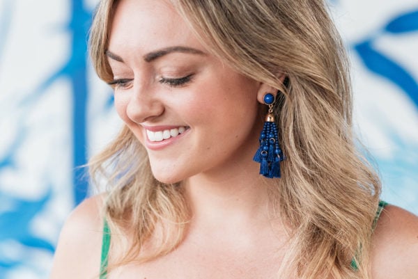 Bows & Sequins wearing a set of blue tassel earrings.