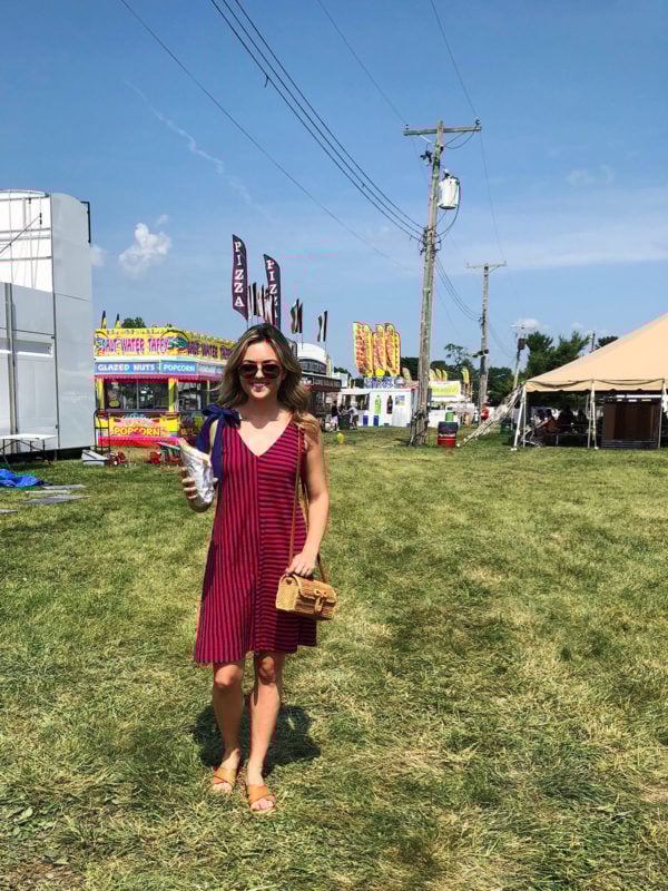 Jessica Sturdy wearing a red and blue striped Vineyard Vines dress with a bow tie shoulder and a wicker bag at the Sangamon County Fair in Illinois.