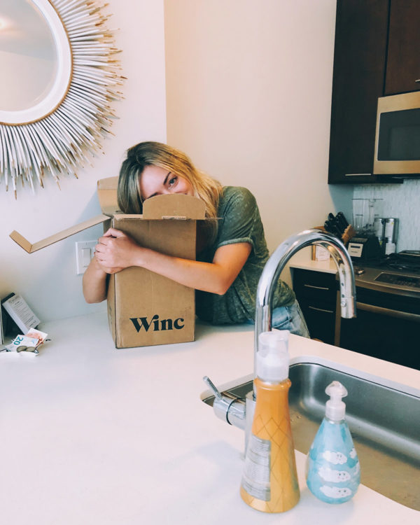 Jessica Sturdy in kitchen with Winc wine subscription box.