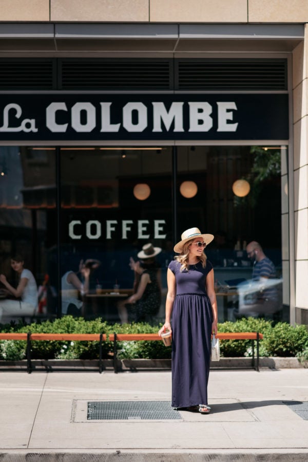 Chicago fashion blogger Jessica Sturdy wearing a striped straw hat and casual maxi dress getting coffee at La Colombe at State & Elm Street.