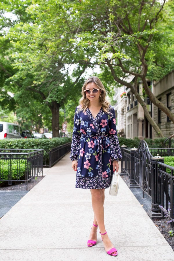 Chicago fashion blogger Bows & Sequins wearing a long sleeve floral wrap dress with pink heels.