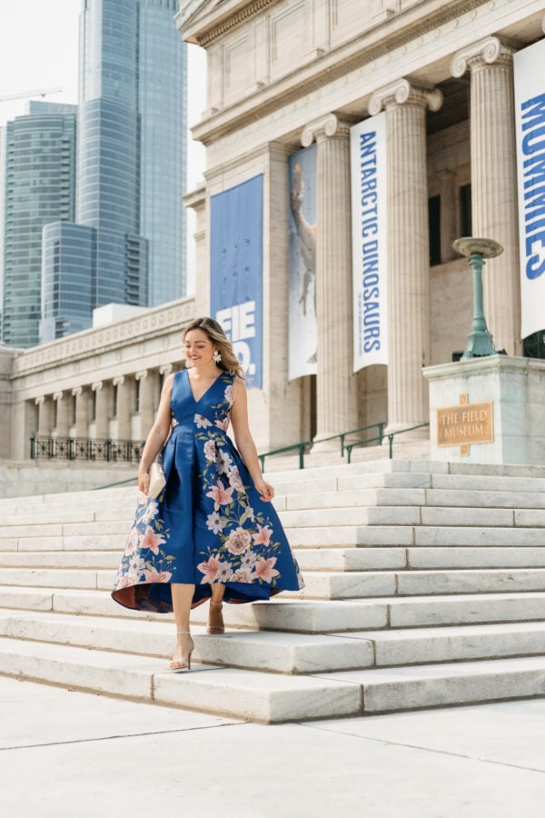 Top Chicago fashion blogger Jessica Sturdy wearing a floral blue Eliza J dress from Nordstrom in front of Chicago's Field Museum for a black tie optional wedding.
