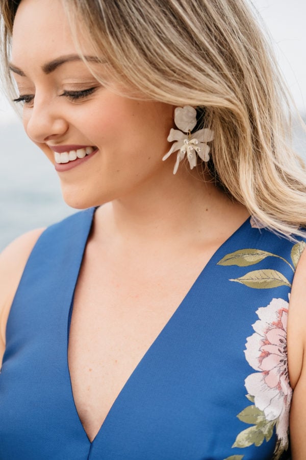Chicago fashion and beauty blogger Jessica Sturdy styling white daffodil Lele Sadhoughi earrings with a blue satin floral dress by Eliza J from Nordstrom.