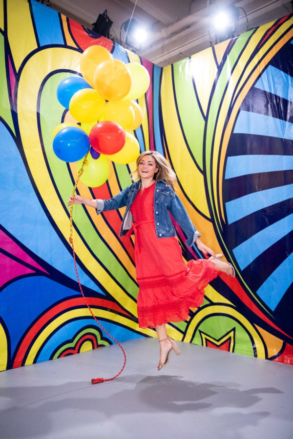 Chicago blogger Jessica Sturdy at Happy Place with red, blue, and yellow balloons.