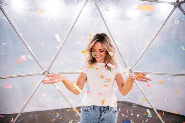 Chicago fashion blogger Jessica Sturdy wearing a Mott & Bow tee shirt at Happy Place throwing confetti.