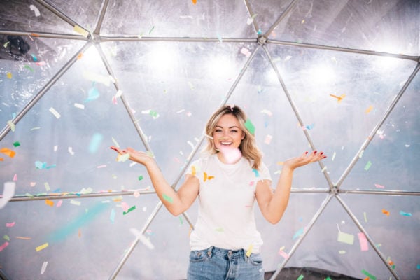 Chicago lifestyle blogger Bows & Sequins throwing paper confetti at Happy Place
