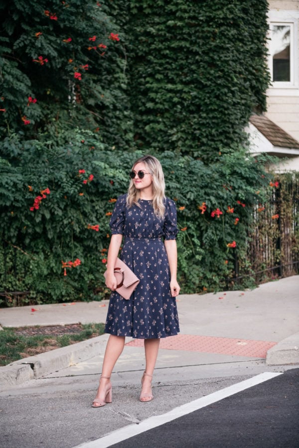 Jessica Sturdy wearing a navy blue floral midi dress with a blush pink clutch to the Create & Cultivate Conference in Chicago