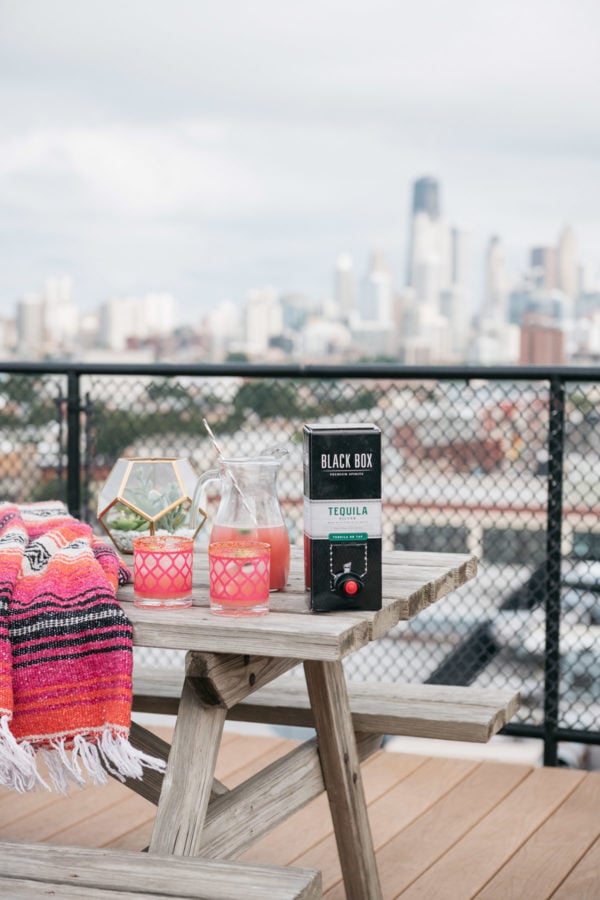 Chicago lifestyle blogger Jessica Sturdy makes a delicious spicy watermelon margarita on a Chicago rooftop with great skyline views.