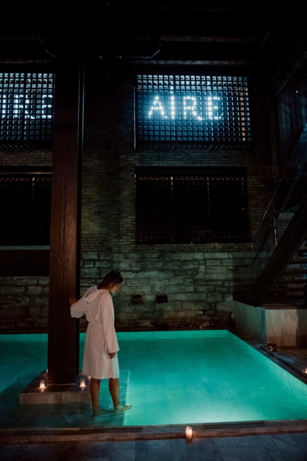 Travel blogger Jessica Sturdy at the Chicago location of AIRE Ancient Baths in a white robe.