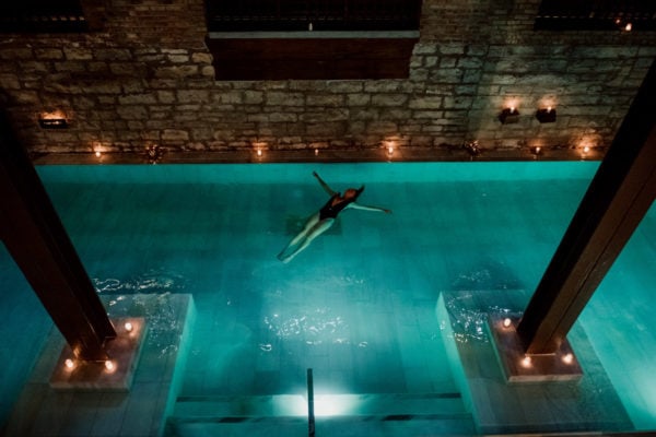 A girl floating in the Flotarium salt bath.