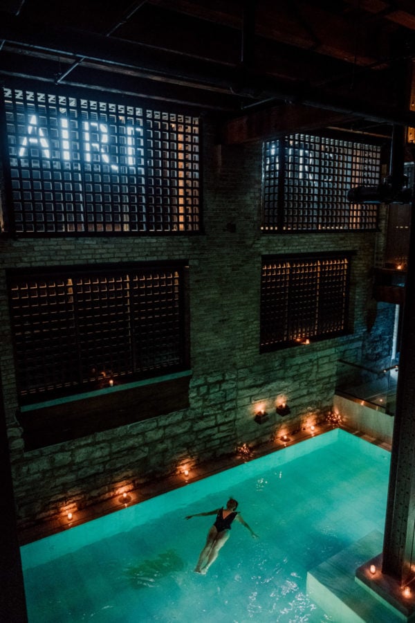Lifestyle blogger Bows & Sequins floating at AIRE Ancient Baths in Chicago.