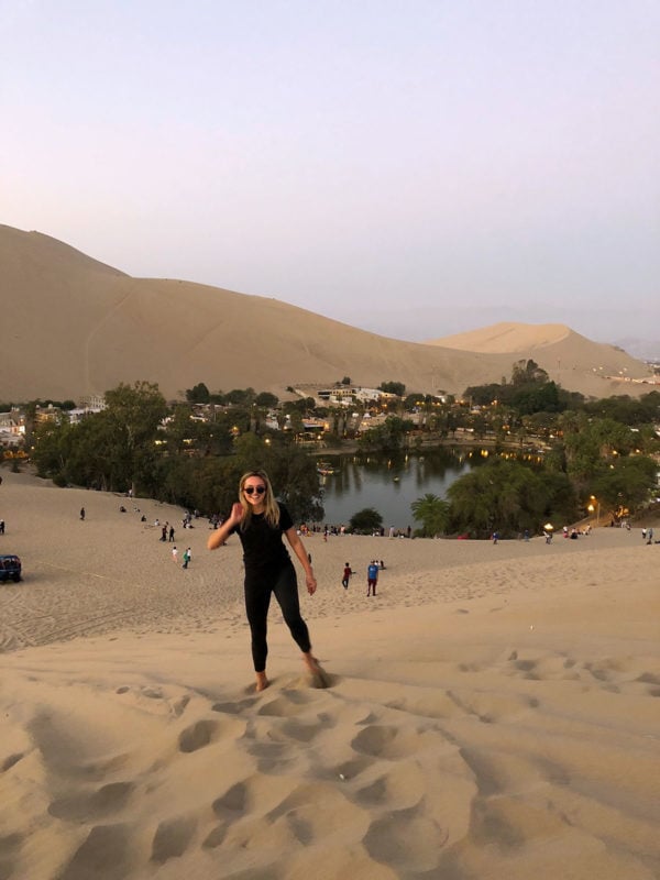 Remote Year travel blogger Jessica Sturdy of Bows & Sequins at the desert oasis of Huacachina in Peru.