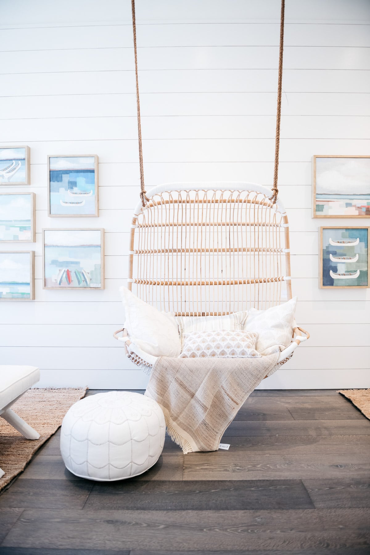 Lifestyle blog Bows & Sequins shares a photo of the hanging wicker swing and gallery wall at Serena & Lily in Chicago.