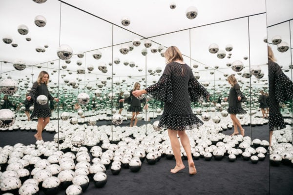 Chicago travel blogger Jessica Sturdy of Bows & Sequins wearing a polka dot bell sleeve dress in the Infinity Mirrors art exhibit. 