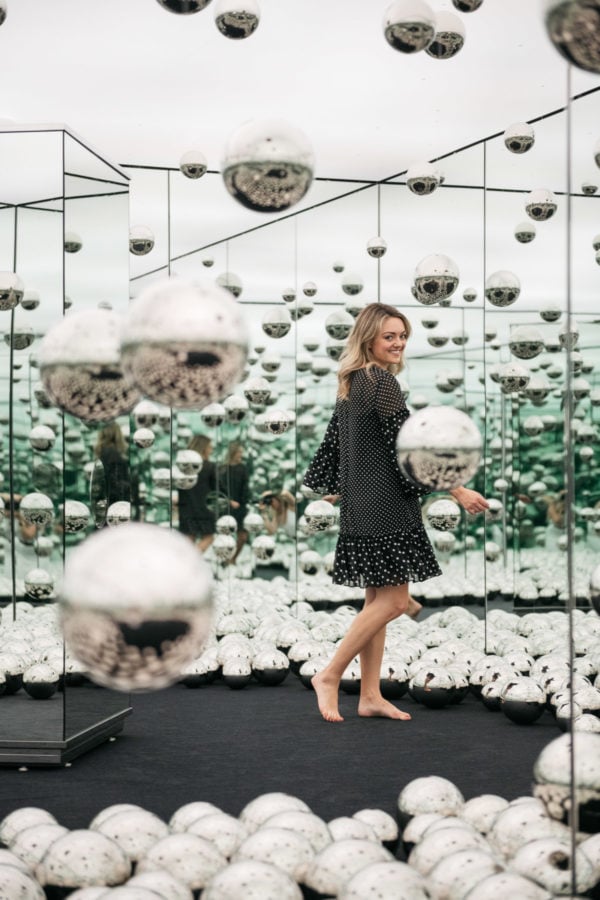 Chicago-based female travel blogger Jessica Sturdy of Bows & Sequins in the Infinity Mirrors room at the wndr museum.