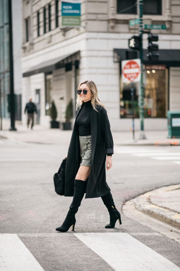 Chicago fashion blogger Jessica Sturdy of Bows & Sequins wearing a black turtleneck, suede skirt, black over the knee boots, and a long black duster coat.
