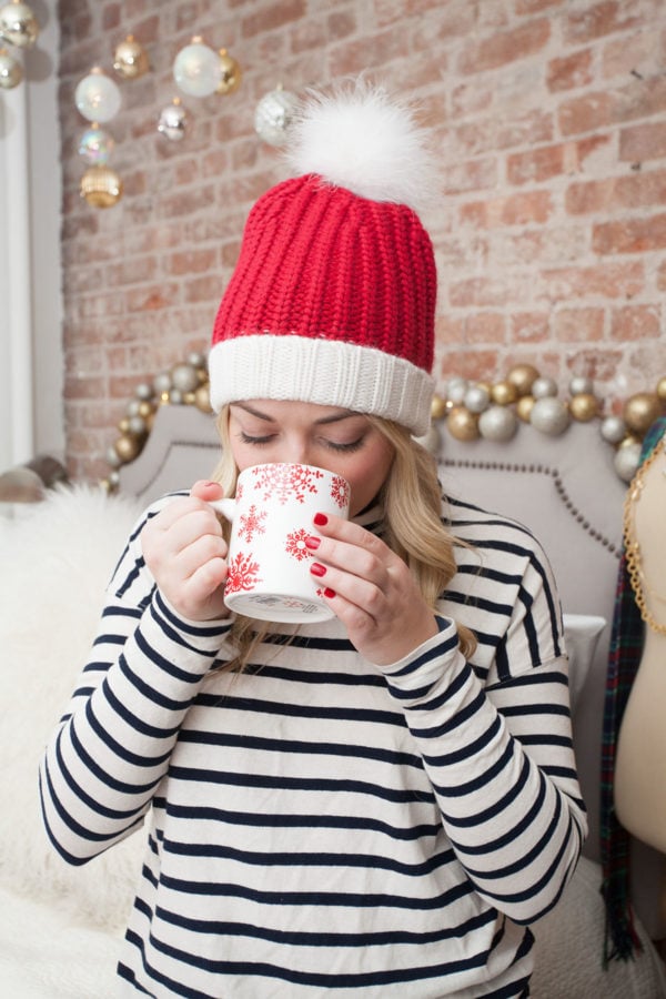 Jessica Sturdy wearing a Kate Spade Santa Hat in her apartment in New York City.