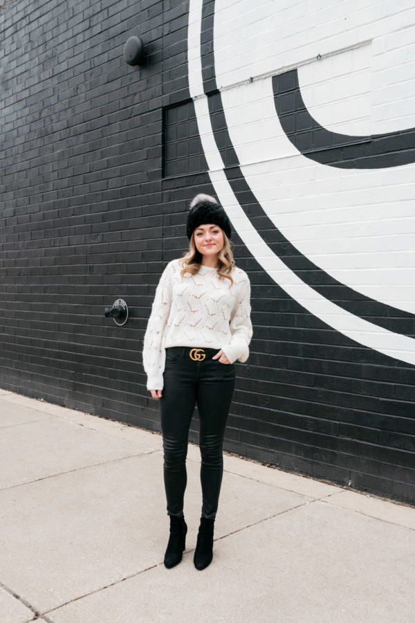 Travel and lifestyle blogger Jessica Sturdy styling a Gucci belt wax coated jeans in Chicago.