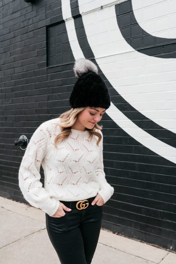 Chicago stylist Jessica Sturdy wearing a simple black and white outfit elevated with a textured hat and Gucci logo belt.