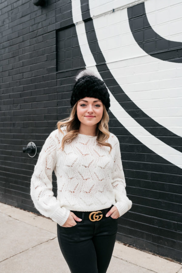 Chicago wardrobe consultant Jessica Sturdy styling a black fur hat, a pointelle sweater, and a Gucci belt.