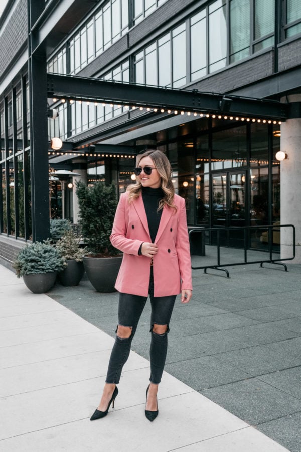 Chicago fashion blogger wearing a pink boyfriend blazer with ripped jeans and a black turtleneck.