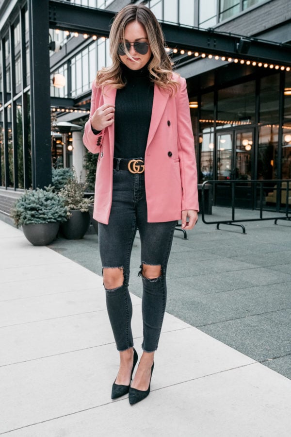 Chicago fashion blogger Jessica Sturdy styles a long pink blazer from Nordstrom with a bodysuit from J.Crew, ripped jeans from Revolve, pointed pumps from Kate Spade, and a Gucci belt.