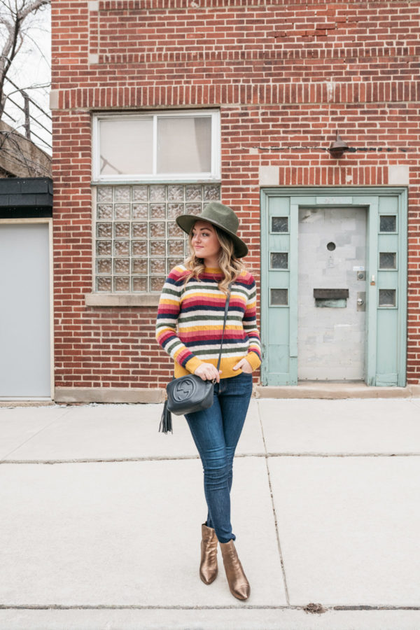 Chicago fashion blogger Jessica Sturdy wearing a cashmere striped sweater, Rag & Bone jeans, and metallic ankle booties.