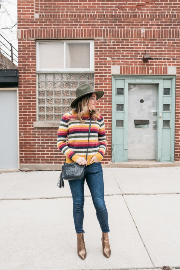 Chicago fashion blogger Jessica Sturdy wearing a cashmere striped sweater, Rag & Bone jeans, and metallic ankle booties.