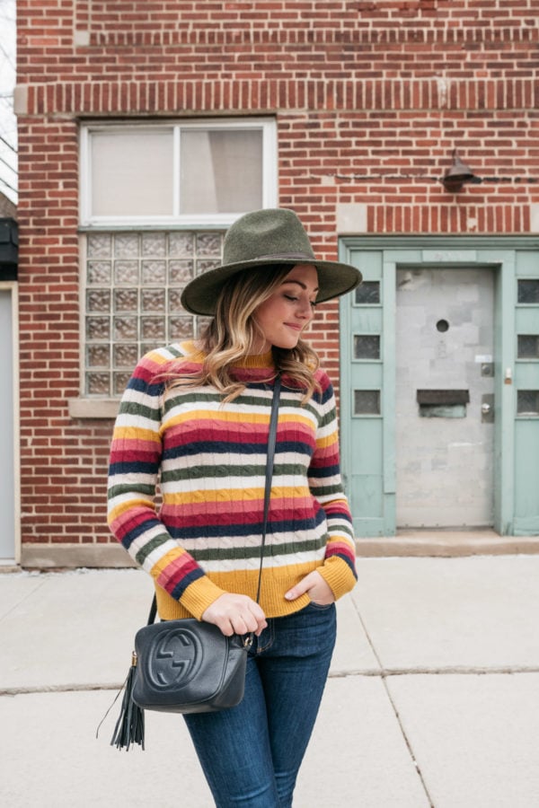 Chicago wardrobe consultant Jessica Sturdy wearing an olive green Barbour hat with a colorful cashmere stripe sweater.