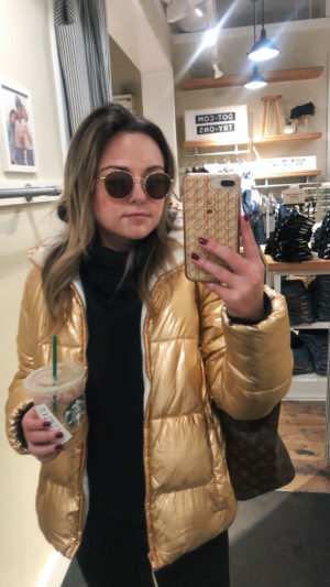 Bows & Sequins tries on a pair of round Madewell sunglasses wearing a rose gold puffer jacket.