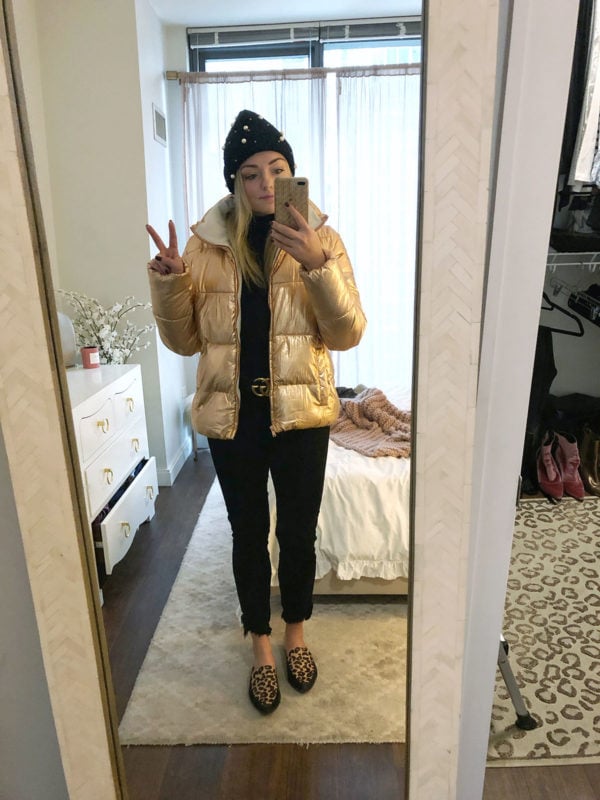 Jessica Sturdy styles a metallic puffer jacket with a Gucci belt, pearl beanie, and leopard slides.