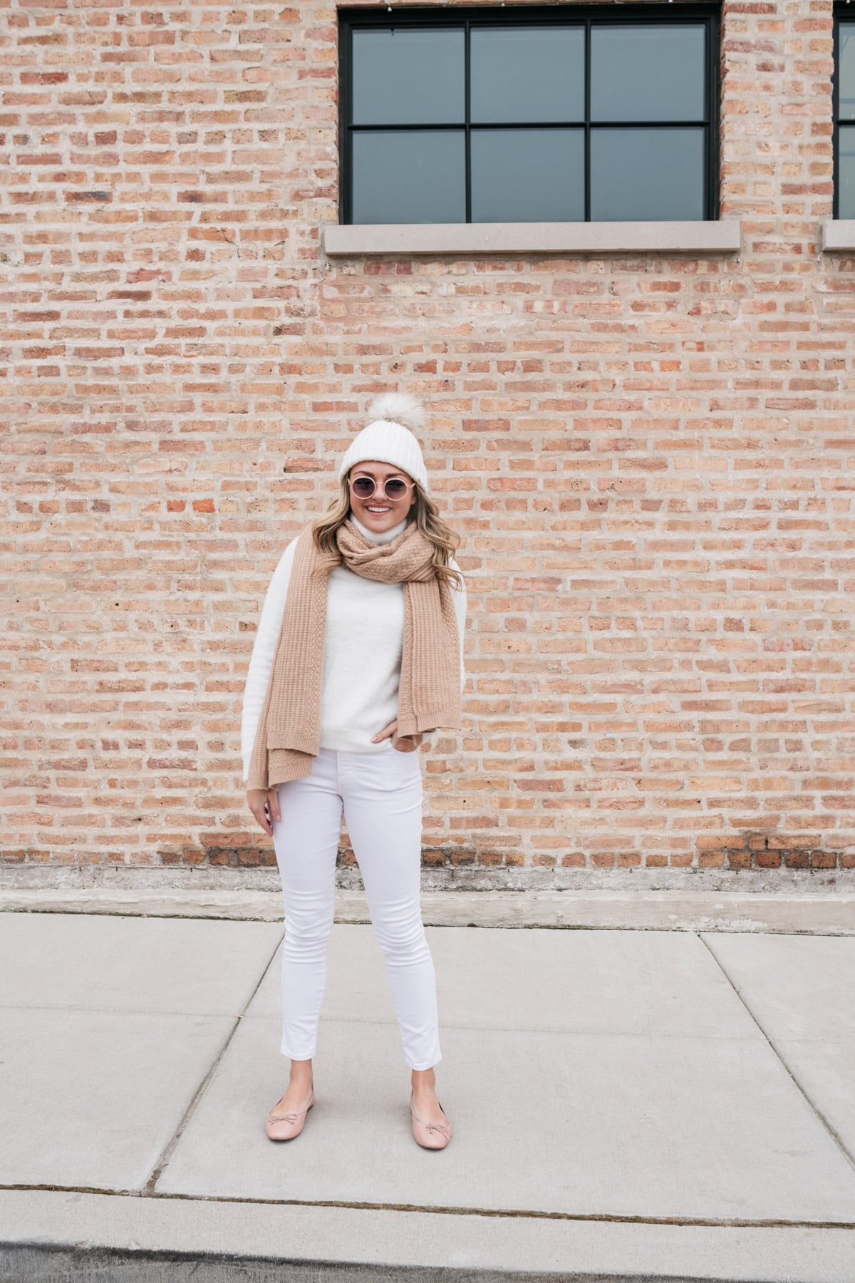 Jessica Sturdy styling a pair of white jeans in the winter.