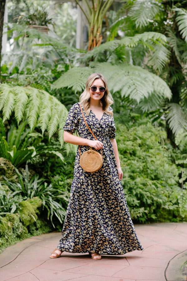 Fashion blogger in Chicago Jessica Sturdy of Bows & Sequins styles a floral maxi dress with a round rattan bag for an easy summer outfit.